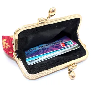 Traditional red brocade coin purse with gold floral pattern and metal clasp closure