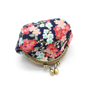 Detailed view of navy blue Japanese cherry blossom pattern on a metal clasp coin purse