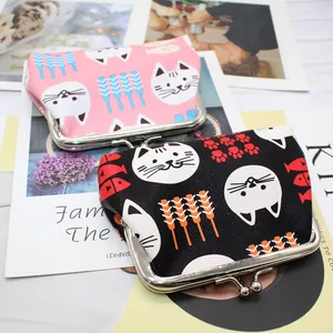 Detail of cartoon cat coin purses with metal kiss-lock clasp in pink and black colors