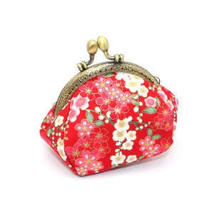Detail of red Japanese floral kiss-lock coin purse with pink cherry blossom pattern