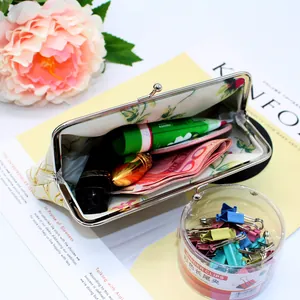 Detailed close-up of retro floral fabric coin purse with metal kiss-lock closure and interior