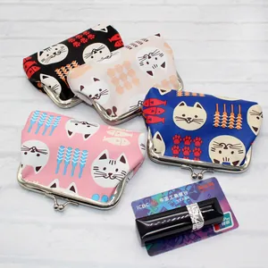 Detailed top view of four Japanese cartoon cat coin purses with metal clasps