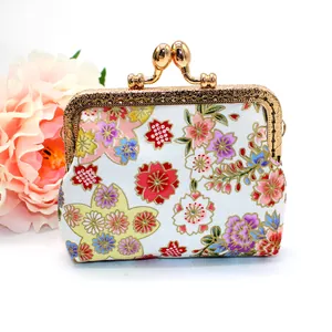 Detail of vintage Japanese floral fabric coin purse with engraved gold metal clasp