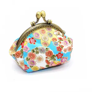 Macro detail of sky blue Japanese floral cotton purse with bronze metal clasp
