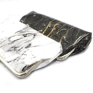 Detail of marble pattern wallets with metal frame closures in black and white PU leather