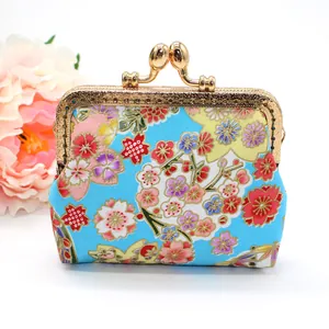 Detail of blue Japanese floral fabric coin purse with cherry blossom pattern and metal clasp