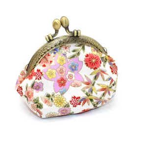 Detailed macro of vintage floral fabric and bronze clasp on a Japanese style coin purse