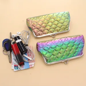 Detail view of iridescent fish scale quilted coin purse with metal frame closure and storage