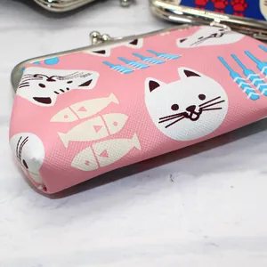Close-up of pink PU leather cat pattern coin purse with silver metal clasp closure