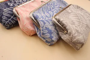 Detail view of colorful fabric coin purses with leaf patterns and metal clasps