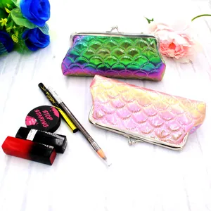 Macro detail of laser scale textured cosmetic bags with metallic clasp closure