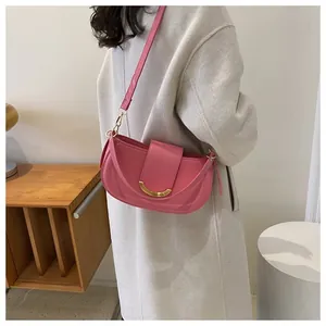 Close-up of pink saddle bag with golden hardware shown from a side-rear angle