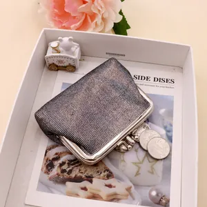 Detail of vintage silver mesh coin purse with kiss lock on a stylish magazine