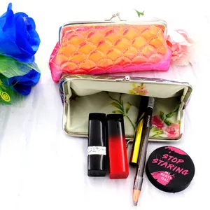 Detailed macro view of laser fish scale coin purse with floral lining and metal kiss lock