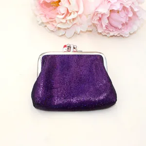 Detailed macro shot of purple glitter PU leather coin purse with silver metal frame clasp