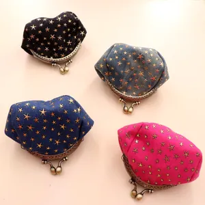 Detail view of denim coin purses with gold stars and retro metal frame bead clasps