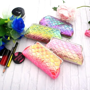 Close-up of colorful laser fish scale coin purses with classic metal kiss lock closures