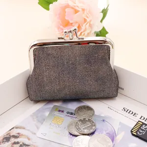 Close-up of vintage silver glitter mini coin purse with classic metal kiss lock closure