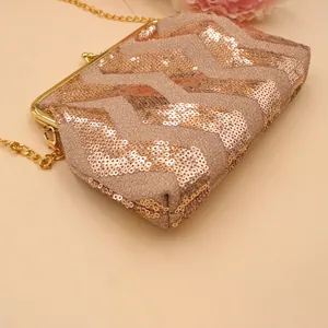 Elegant champagne gold wave sequin evening clutch bag with metal frame and chain strap