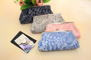 Close-up of fabric coin purses with leaf patterns and vintage metal clasps in four colors