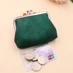 Macro view of green glitter coin purse with silver metal frame closure and coins