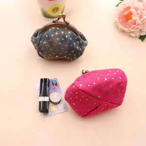 Detail of star pattern denim coin purses with metal clasps showing size with cards