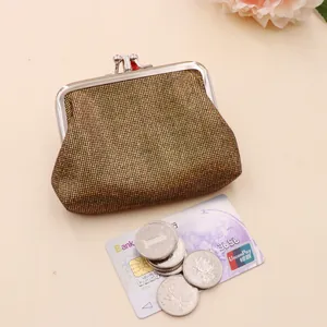 Detailed view of vintage gold mesh coin purse with silver clasp, cards and coins