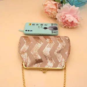 Detail of wavy sequin mini bag featuring golden metal frame and chain strap