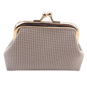 Close-up van een vintage ruitjes portemonnee met een gouden metalen kiss-lock sluiting