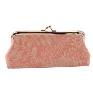 Detail view of pink leaf print canvas coin purse with silver vintage metal kiss lock clasp