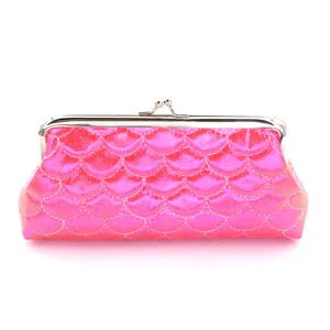 Detail of pink mermaid scale textured purse with silver metal kiss-lock closure