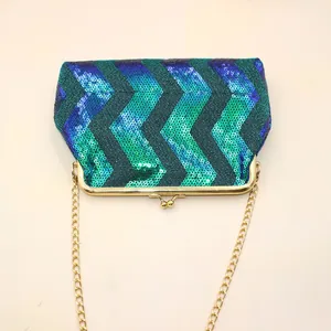 Macro detail of wave sequins with gold kiss-lock closure and metal chain strap