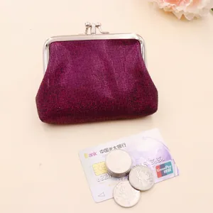 Close-up of small glitter sequin coin purse with silver metal kiss-lock clasp