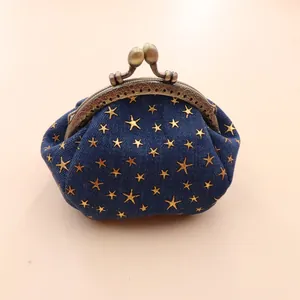 Detailed view of denim coin purse with gold star embroidery and vintage metal clasp