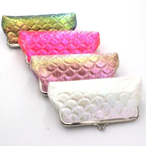 Macro view of four colorful laser fish scale purses with silver kiss-lock closures