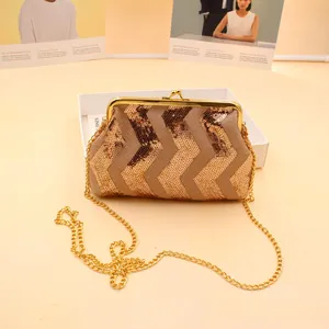 Detail of sequin evening bag with chevron pattern and vintage gold metal kiss-lock