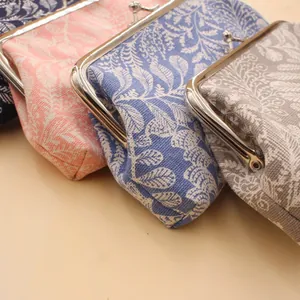 Vintage kiss-lock coin purses in cotton fabric with elegant white leaf patterns