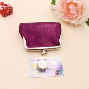 Macro shot of purple metal mesh coin purse with classic silver clasp and bank card for scale