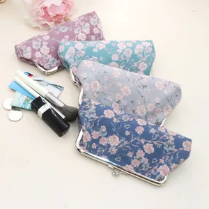 Close-up of vintage floral fabric coin purses with silver metal clasps and cotton lining