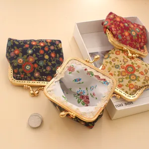 Macro detail of handmade floral coin purse with vintage gold metal clasp and lace lining