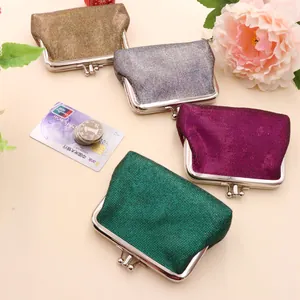 Close-up of retro PU leather wallets in metallic gold, silver, purple and green tones