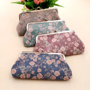 Detail view of four floral canvas purses with metal clasps in various elegant colors