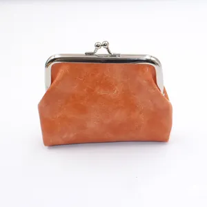 Macro-opname van vintage oranje PU-waxlederen portemonnee met metalen kliksluiting