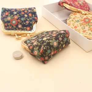 Detail view of colorful floral fabric coin purses with vintage metal kiss-lock frames