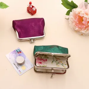 Detailed view of mini PU coin purses in dark purple and green with floral lining