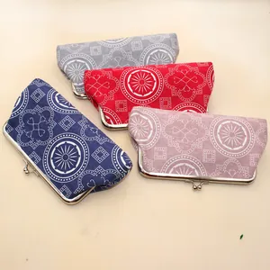 Detail of four colorful canvas kiss-lock coin purses with vintage geometric floral patterns