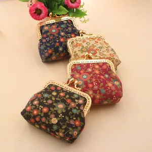 Detail view of four vintage floral fabric coin purses with metal clasps and ethnic patterns