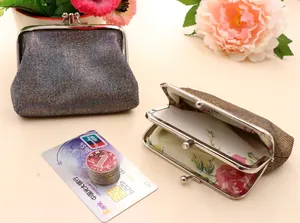 Detailed view of the double-layer interior with floral lining and secure kiss-lock closure