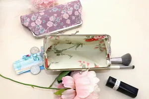 Detailed view of vintage floral purse interior with coins and makeup accessories