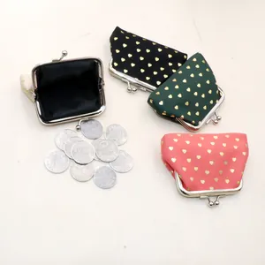 Top view of fabric coin purses with gold heart patterns in four colors and metal frames